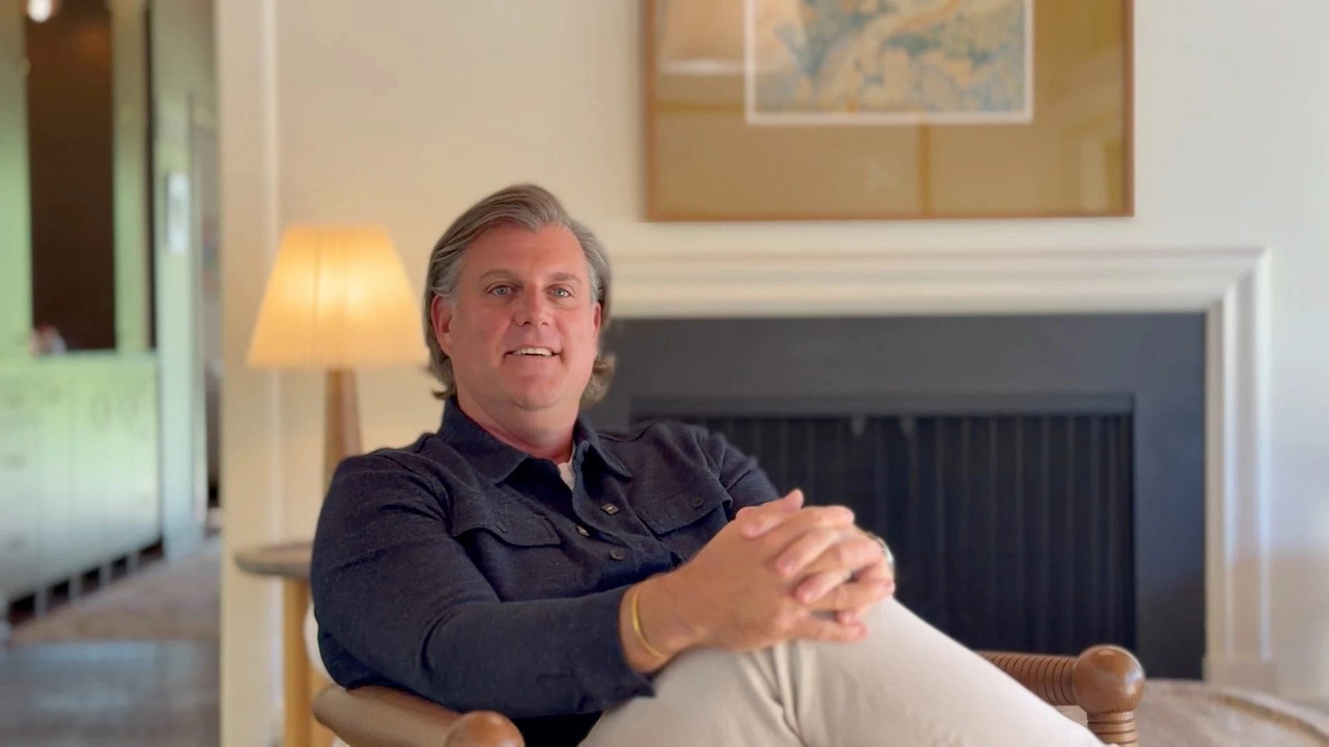 Andrew Peters, founder of Silent Partners, seated in an armchair in front of a fireplace